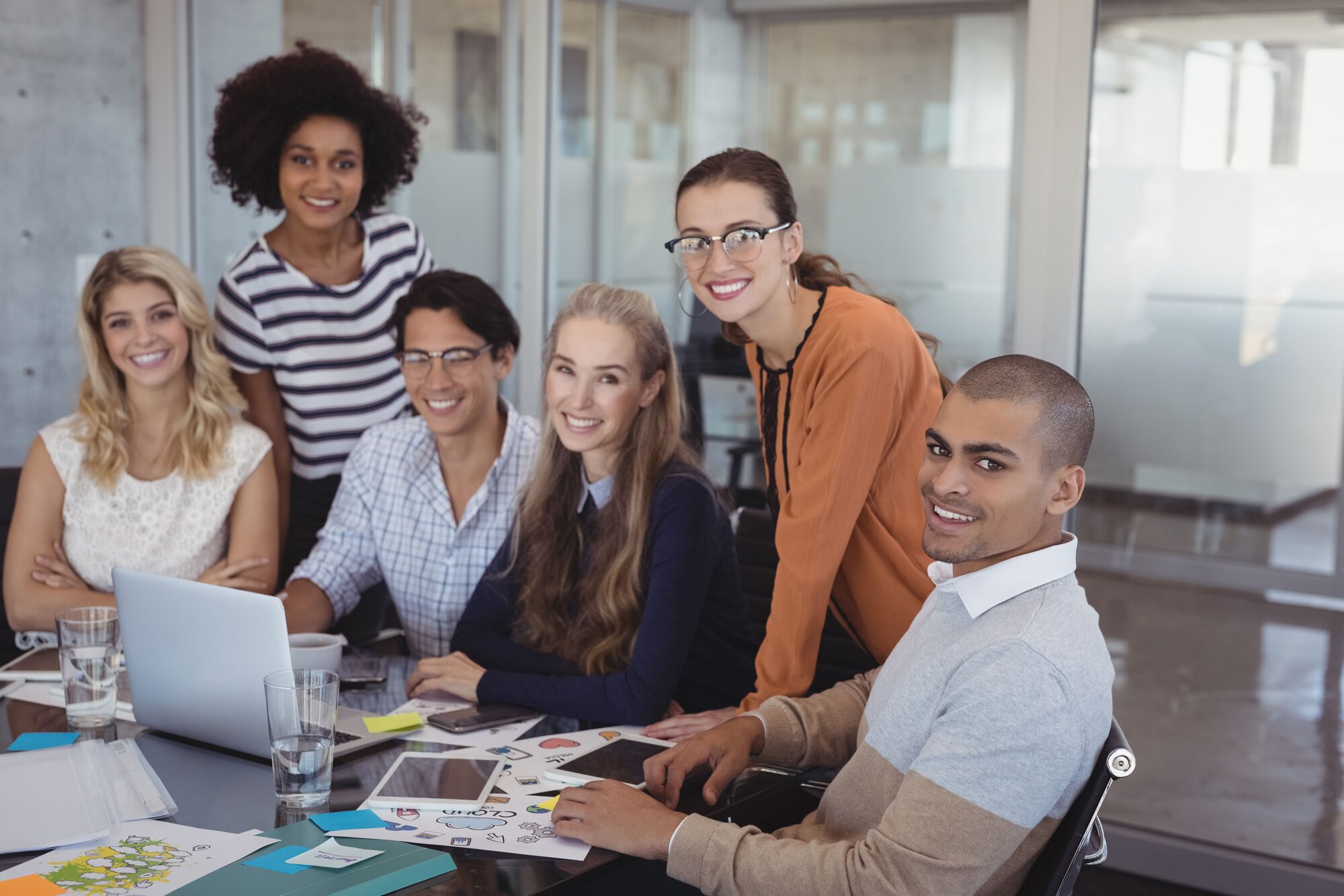 A diverse consulting team collaborating around a table in a modern office